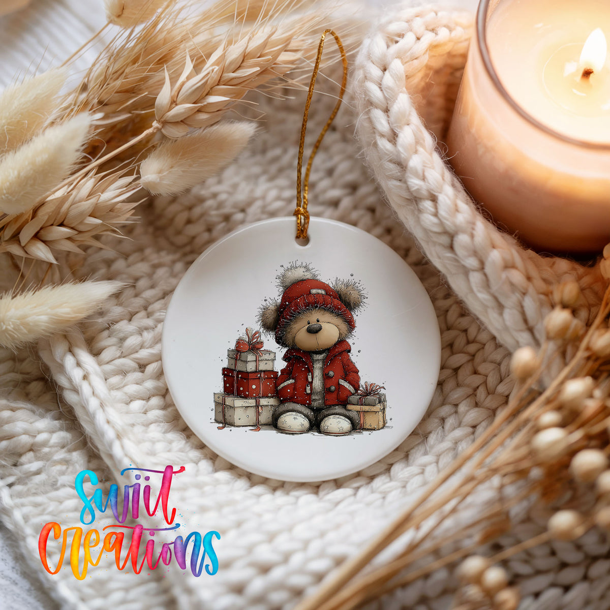 teddy bear in a red coat beside Christmas gifts ceramic Christmas ornament styled on a cozy knit blanket