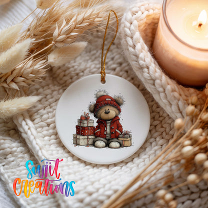 teddy bear in a red coat beside Christmas gifts ceramic Christmas ornament styled on a cozy knit blanket