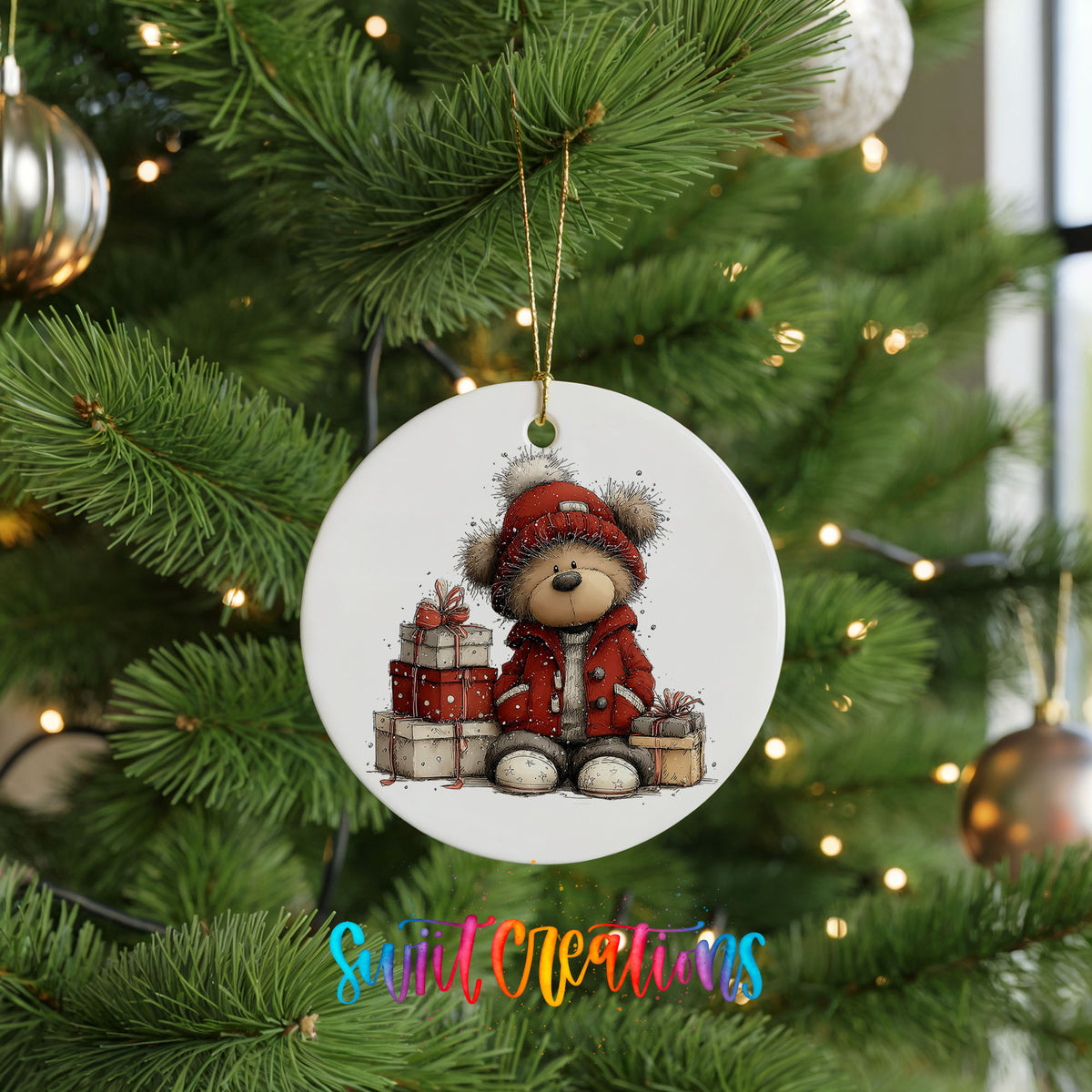 teddy bear in a red coat beside Christmas gifts ceramic Christmas ornament hanging on a lit Christmas tree