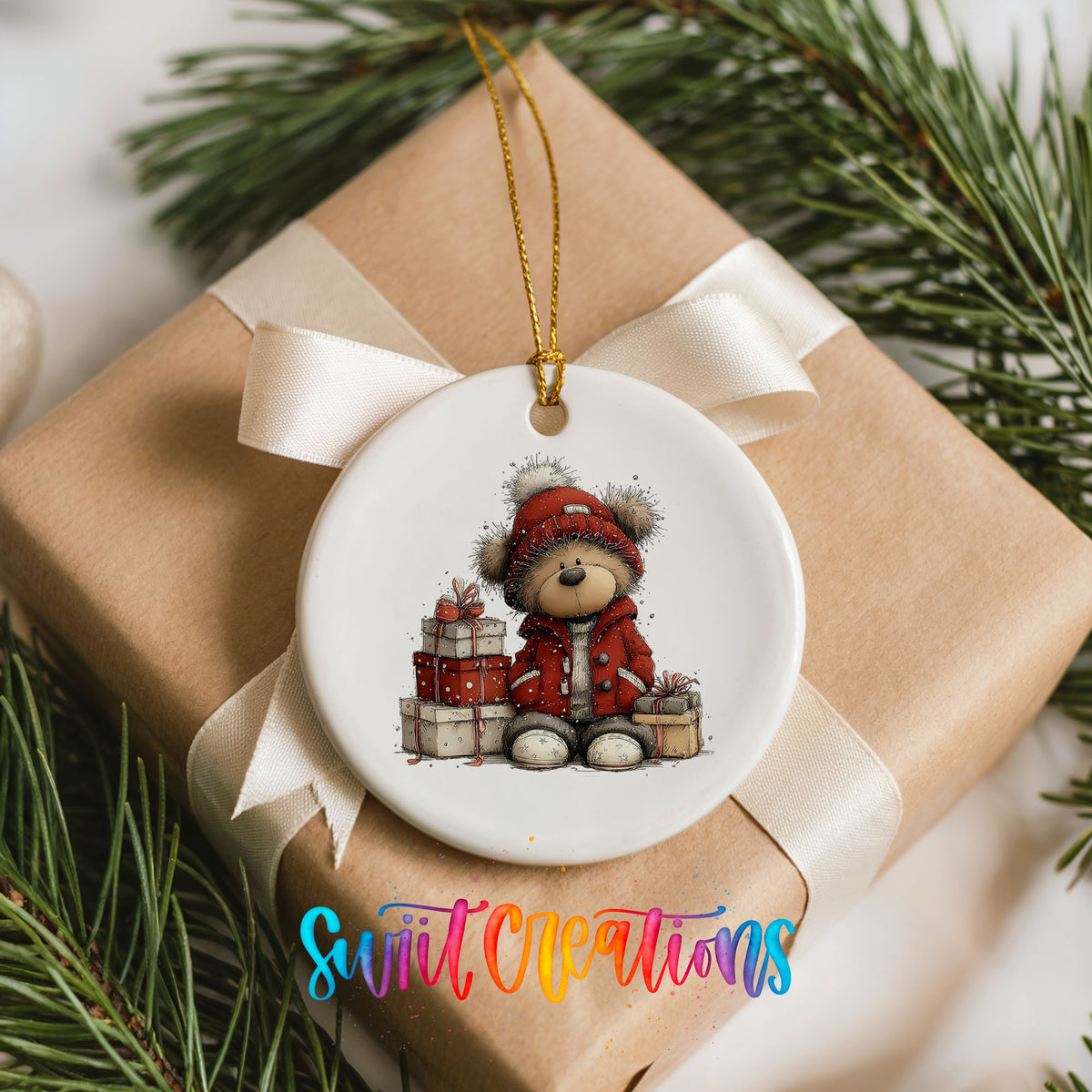 teddy bear in a red coat beside Christmas gifts ceramic Christmas ornament displayed on a wrapped Christmas gift