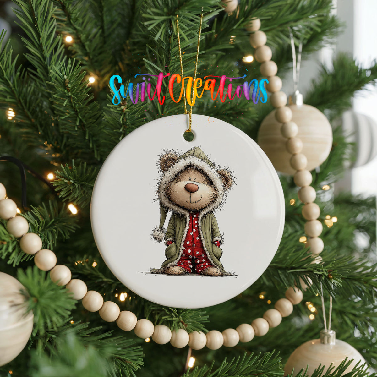 teddy bear in a gray hooded winter coat ceramic Christmas ornament hanging on a green Christmas tree