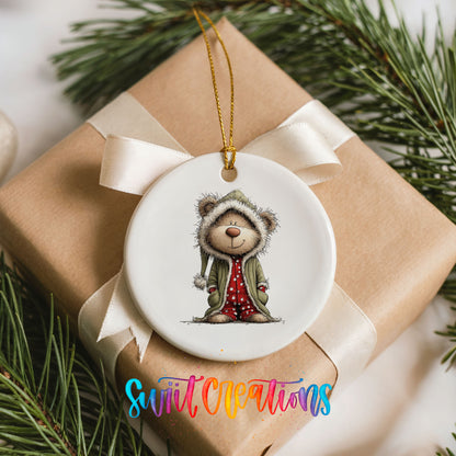 teddy bear in a gray hooded winter coat ceramic Christmas ornament displayed on a wrapped Christmas gift