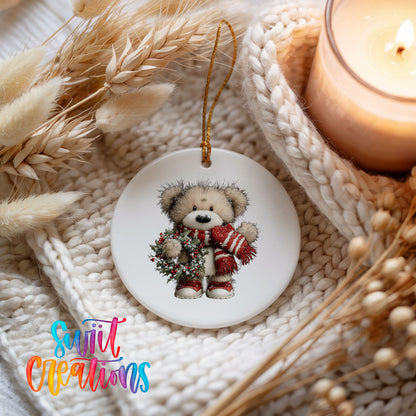 teddy bear with a red striped scarf and holly wreath ceramic Christmas ornament styled on a cozy knit blanket
