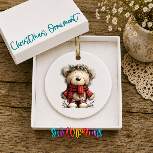 teddy bear in a red plaid scarf with holly ceramic Christmas ornament presented in a gift box