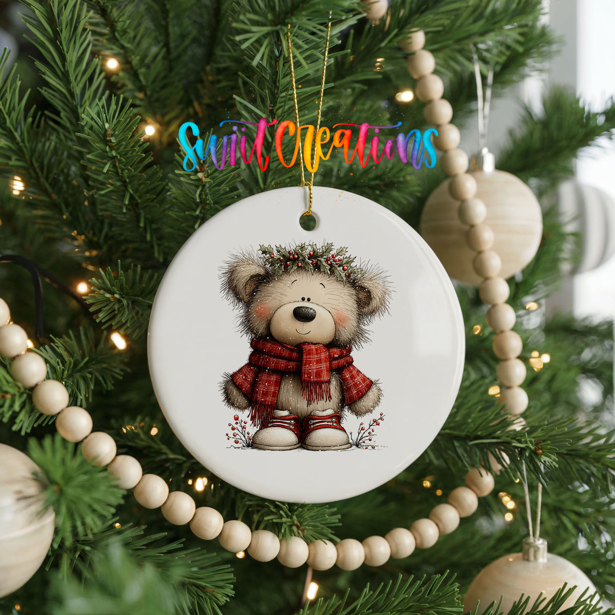 teddy bear in a red plaid scarf with holly ceramic Christmas ornament hanging on a green Christmas tree