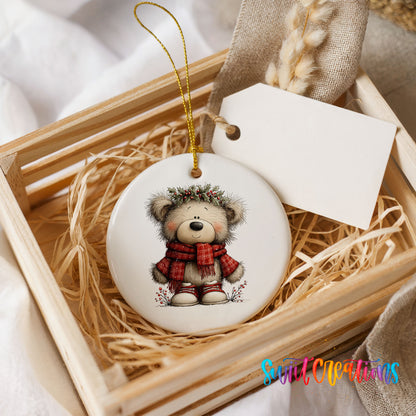 teddy bear in a red plaid scarf with holly ceramic Christmas ornament displayed in a wooden gift crate