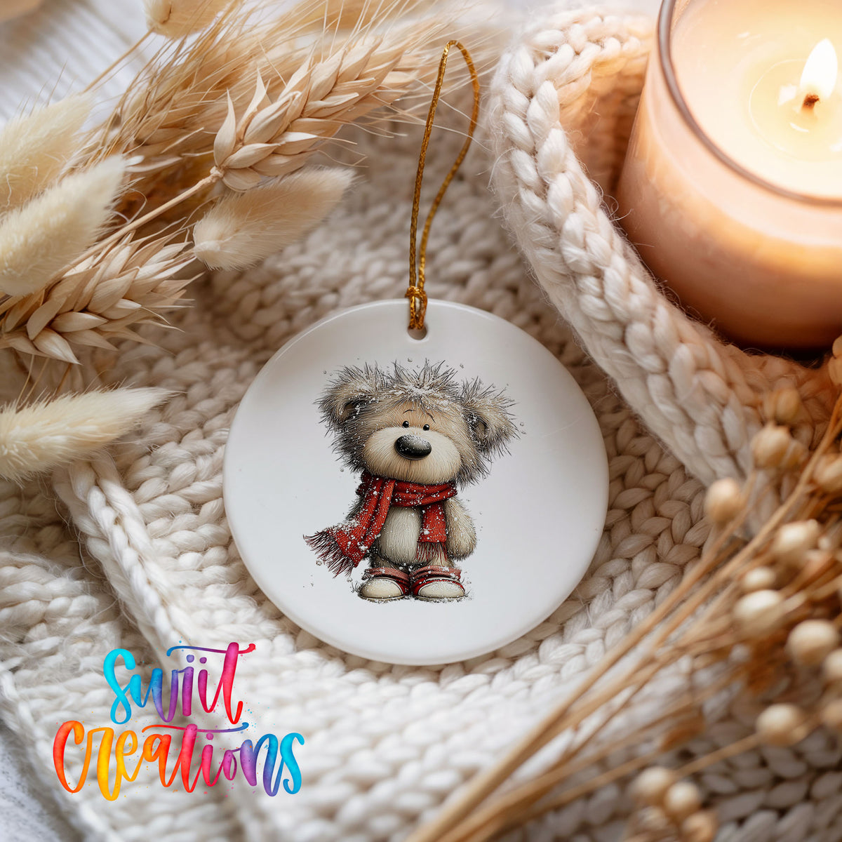 teddy bear in a red scarf standing in the snow ceramic Christmas ornament styled on a cozy knit blanket