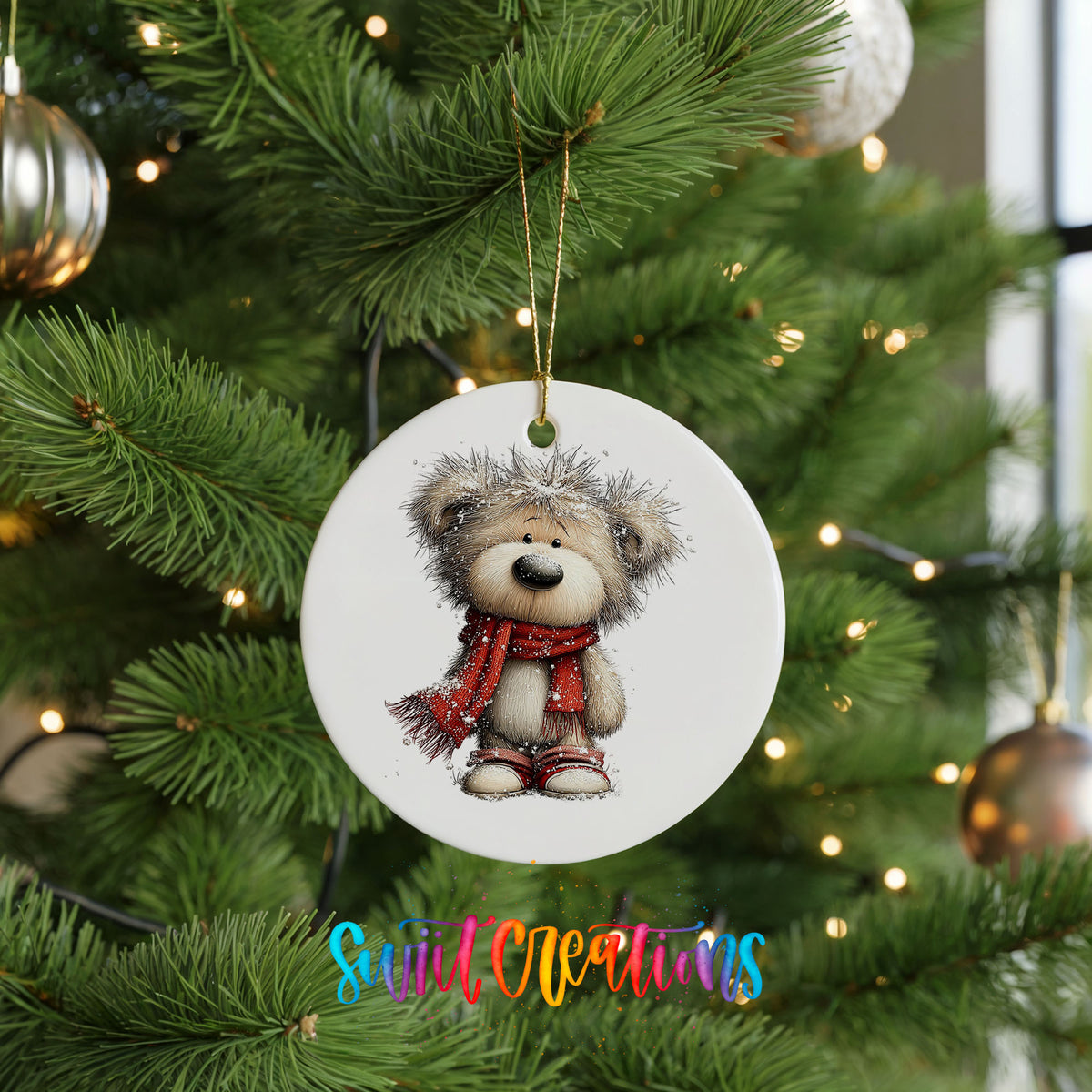 teddy bear in a red scarf standing in the snow ceramic Christmas ornament hanging on a lit Christmas tree