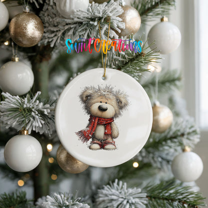 teddy bear in a red scarf standing in the snow ceramic Christmas ornament hanging on a frosted tree with ornaments