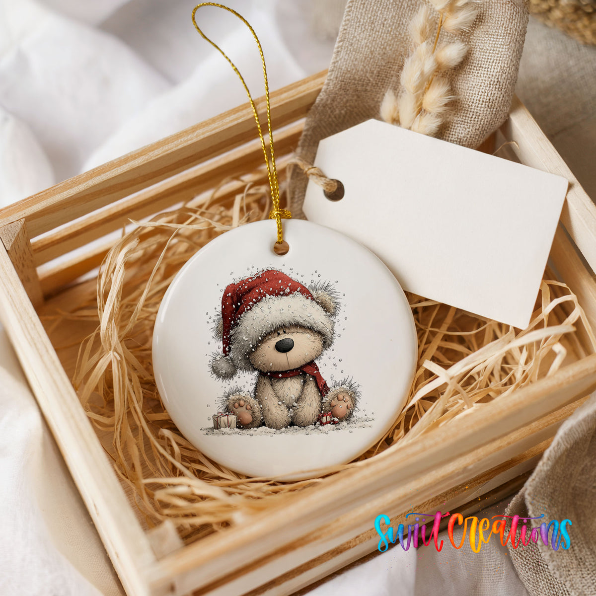 seated teddy bear in a red Santa hat ceramic Christmas ornament displayed in a wooden gift crate