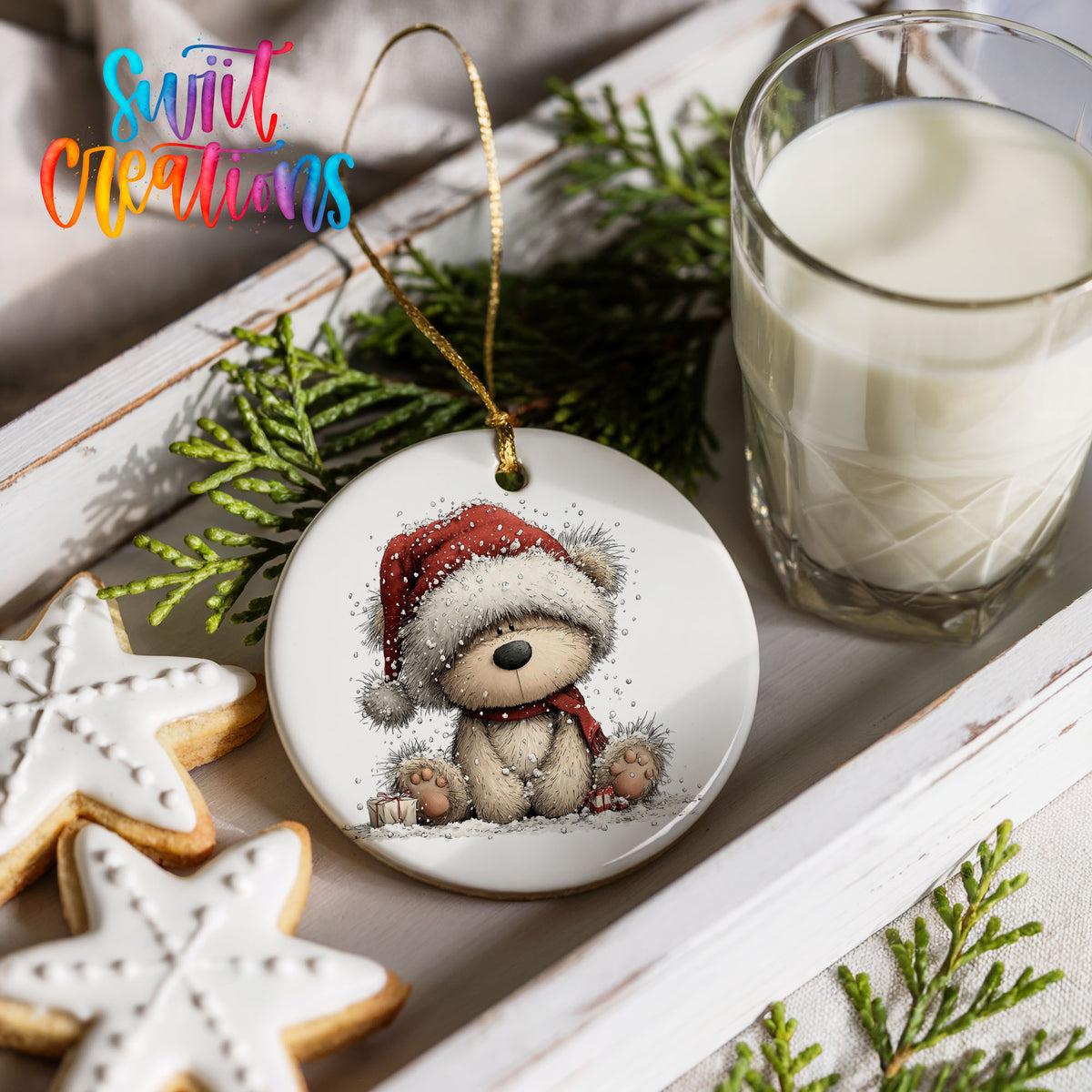 seated teddy bear in a red Santa hat ceramic Christmas ornament styled with holiday cookies and a candle