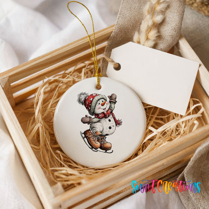 snowman ice skating in a red winter hat ceramic Christmas ornament displayed in a wooden gift crate