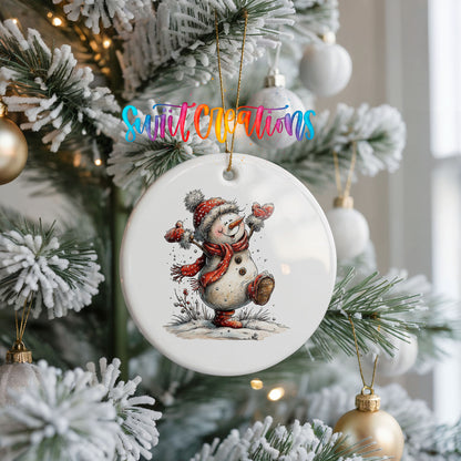 playful snowman in a red scarf ceramic Christmas ornament hanging on a frosted Christmas tree