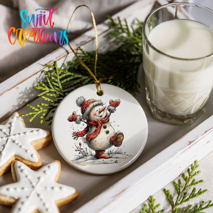 playful snowman in a red scarf ceramic Christmas ornament styled with holiday cookies and a candle
