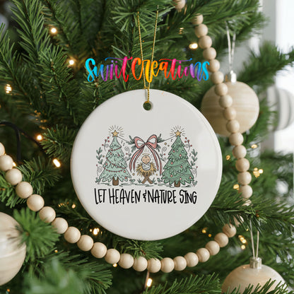 Let Heaven and Nature Sing church and winter trees design ceramic Christmas ornament hanging on a green Christmas tree