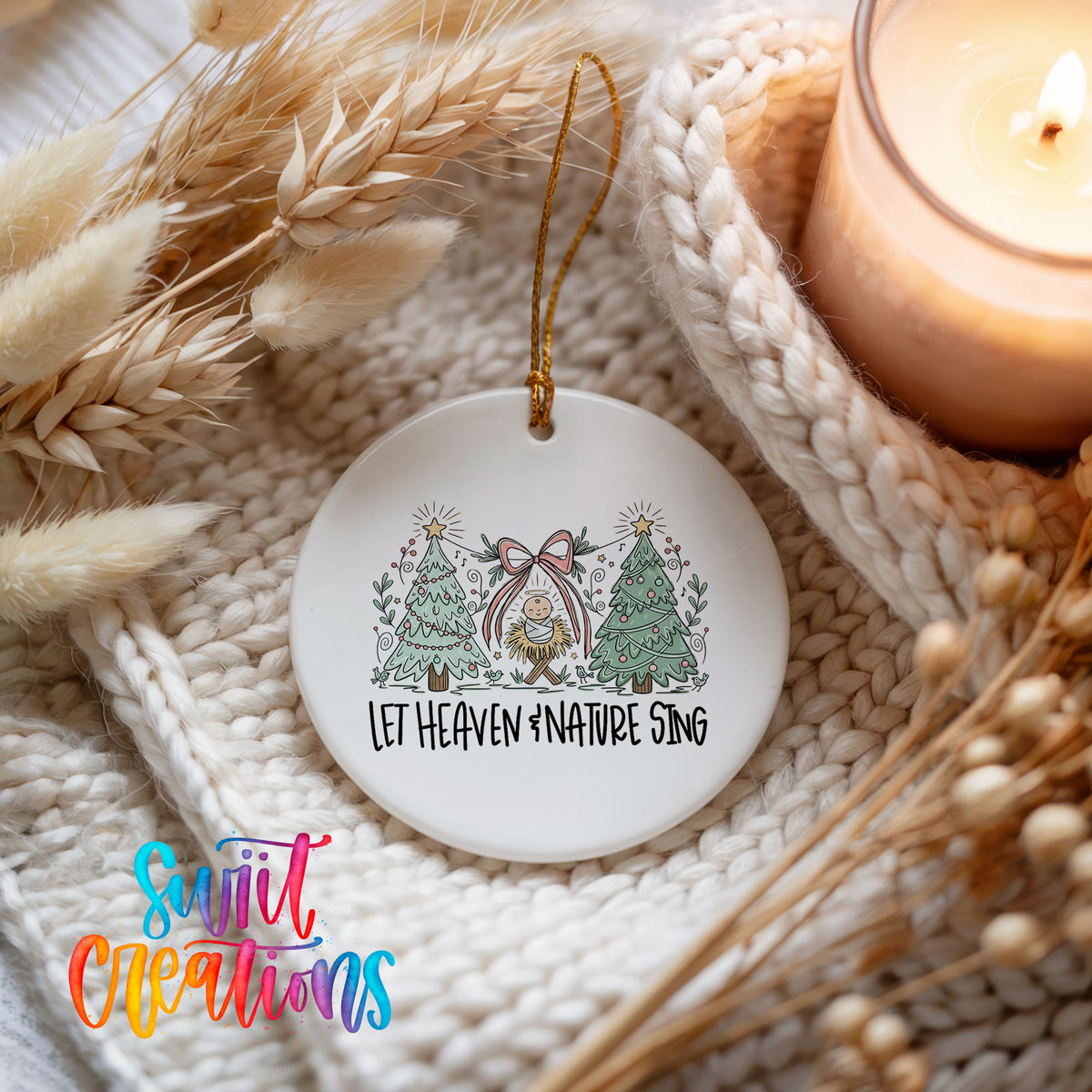 Let Heaven and Nature Sing church and winter trees design ceramic Christmas ornament styled on a cozy knit blanket
