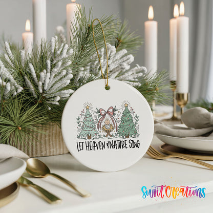 Let Heaven and Nature Sing church and winter trees design ceramic Christmas ornament shown in a holiday table setting