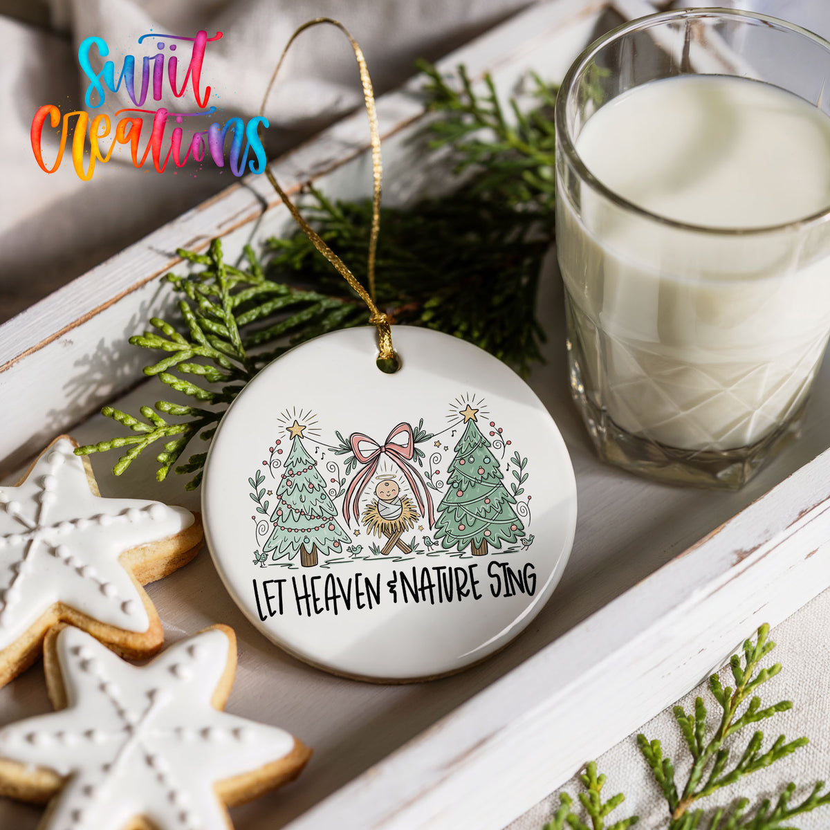 Let Heaven and Nature Sing church and winter trees design ceramic Christmas ornament styled with holiday cookies and a candle