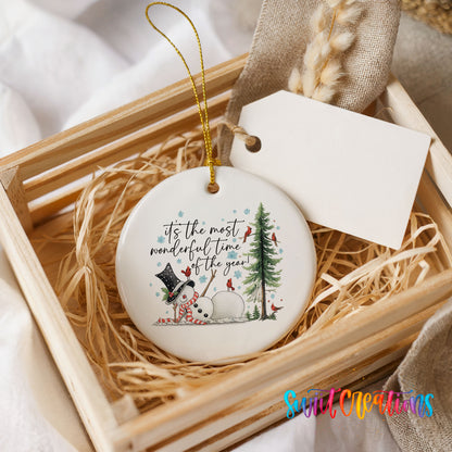 It's the Most Wonderful Time of the Year snowman design ceramic Christmas ornament displayed in a wooden gift crate