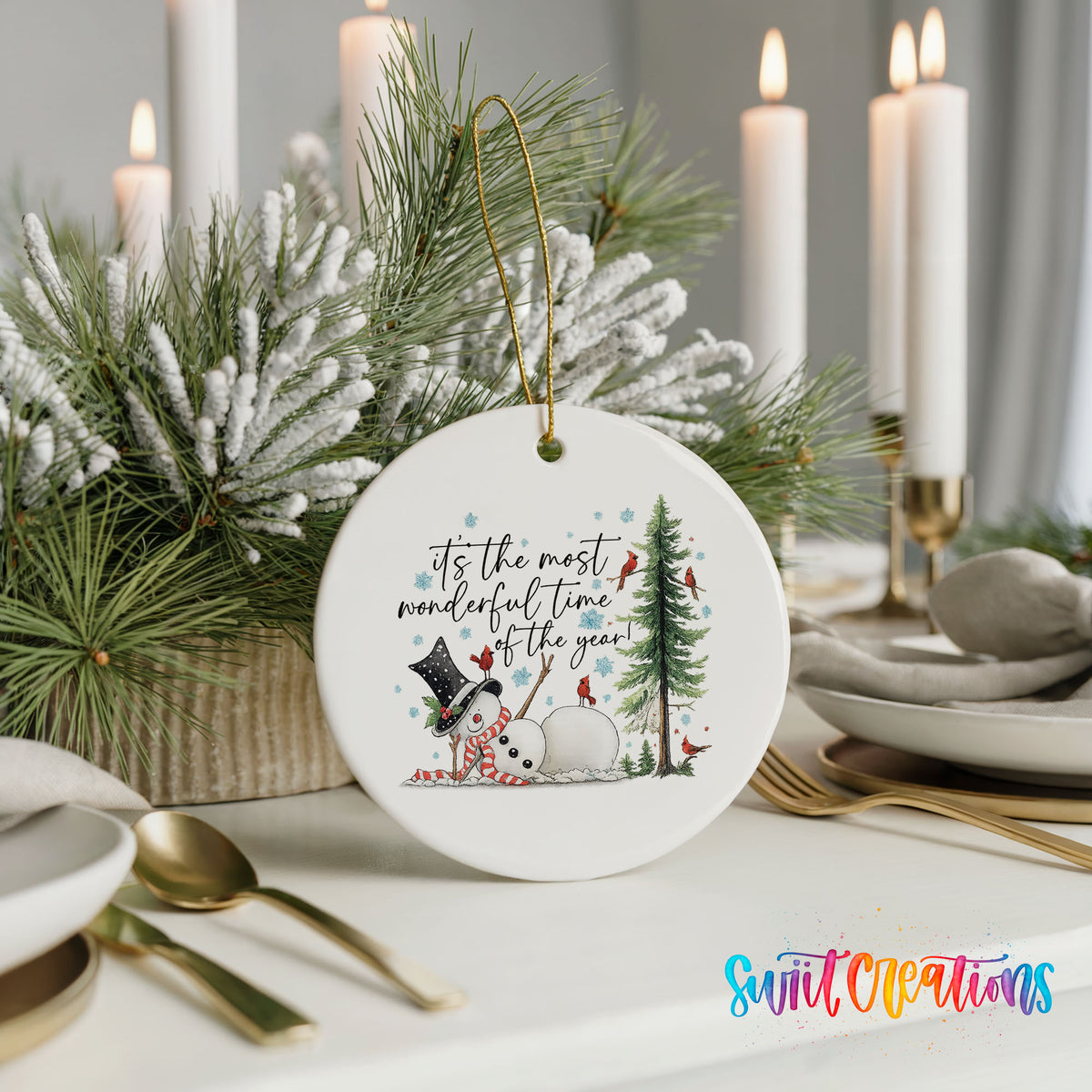It's the Most Wonderful Time of the Year snowman design ceramic Christmas ornament shown in a holiday table setting