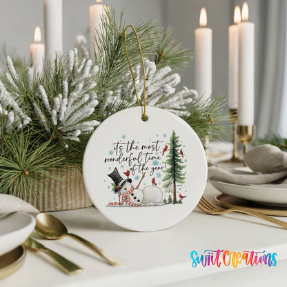 It's the Most Wonderful Time of the Year snowman design ceramic Christmas ornament shown in a holiday table setting
