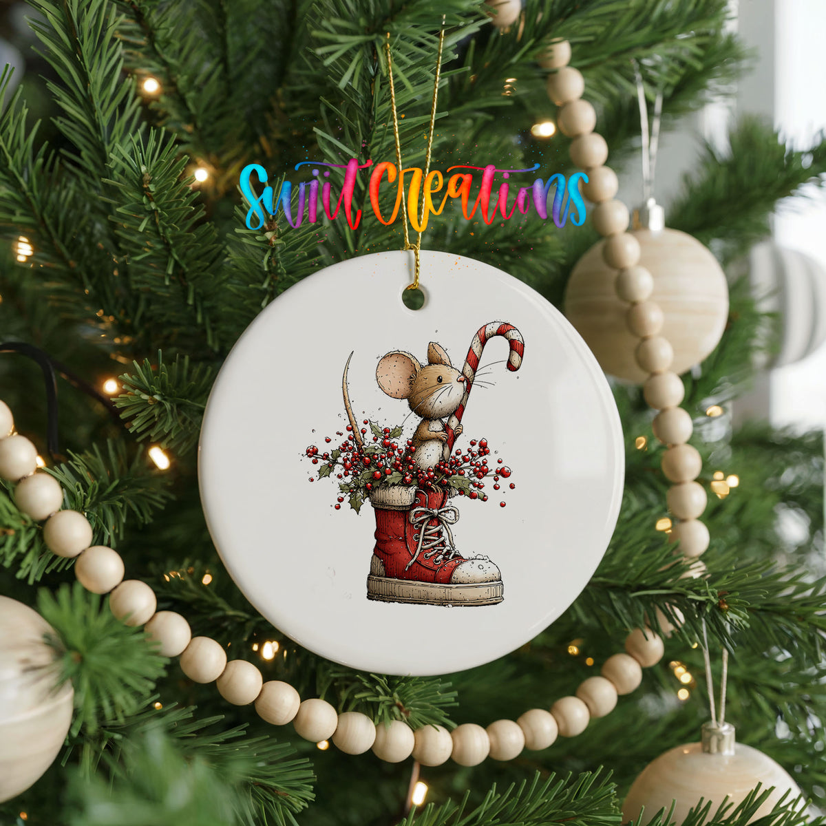 woodland mouse with a candy cane in a Christmas stocking ceramic Christmas ornament hanging on a green Christmas tree