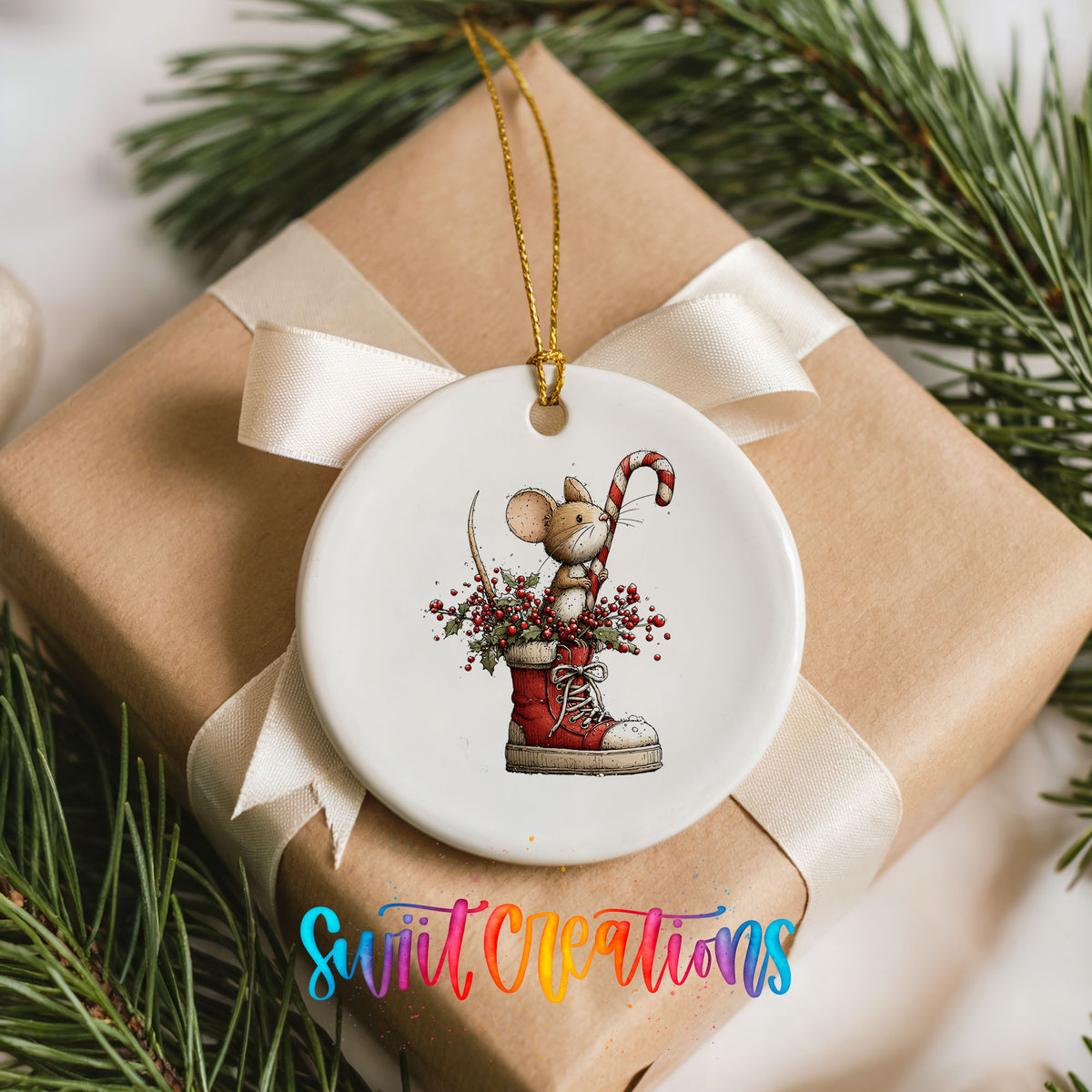 woodland mouse with a candy cane in a Christmas stocking ceramic Christmas ornament displayed on a wrapped Christmas gift