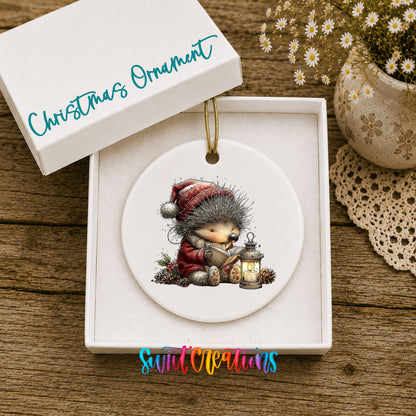 woodland bear in a Santa hat holding a lantern ceramic Christmas ornament presented in a gift box