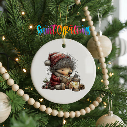 woodland bear in a Santa hat holding a lantern ceramic Christmas ornament hanging on a green Christmas tree