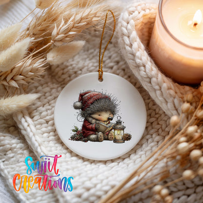 woodland bear in a Santa hat holding a lantern ceramic Christmas ornament styled on a cozy knit blanket