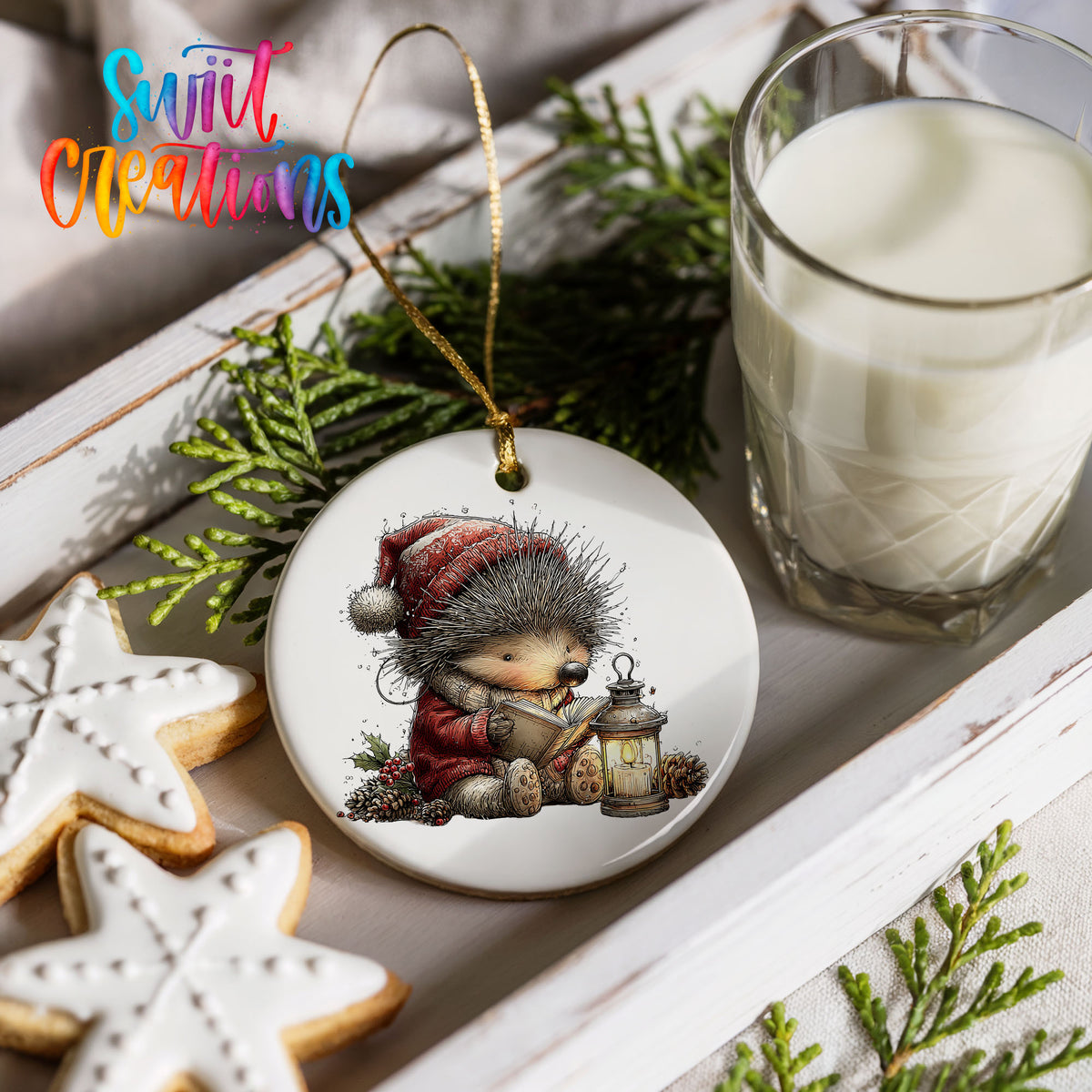 woodland bear in a Santa hat holding a lantern ceramic Christmas ornament styled with holiday cookies and a candle