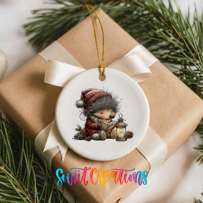 woodland bear in a Santa hat holding a lantern ceramic Christmas ornament displayed on a wrapped Christmas gift