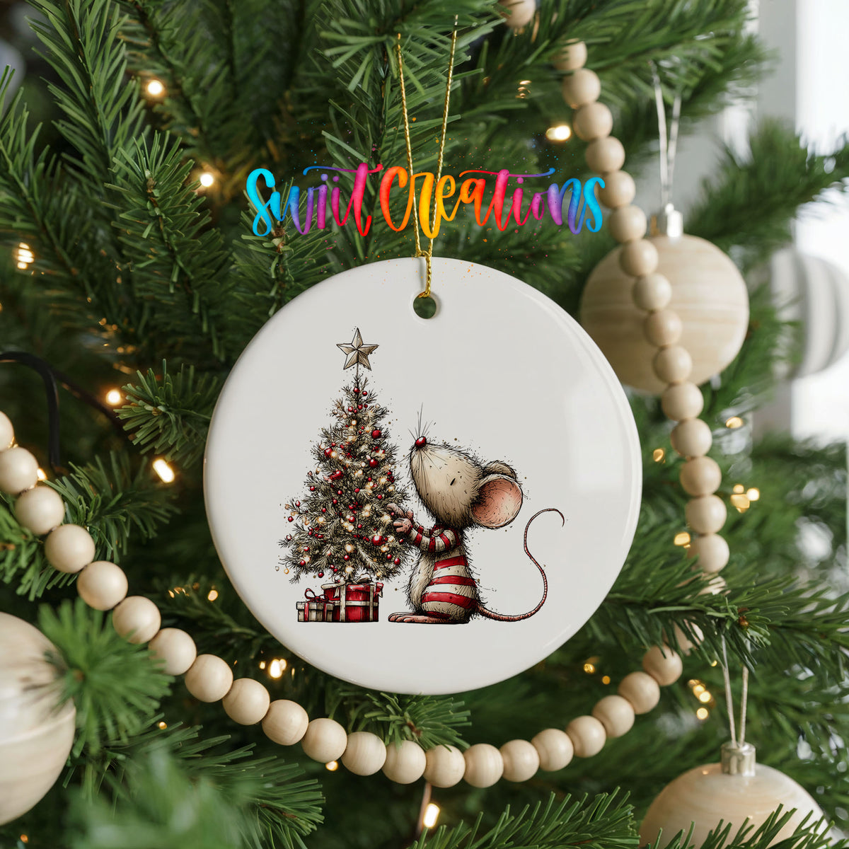 woodland mouse beside a decorated Christmas tree ceramic Christmas ornament hanging on a green Christmas tree