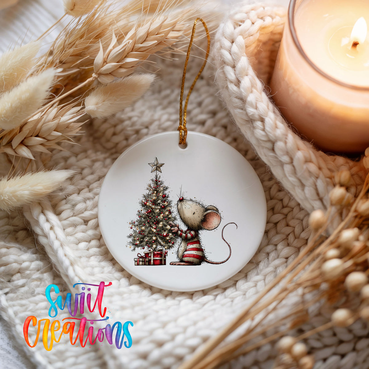woodland mouse beside a decorated Christmas tree ceramic Christmas ornament styled on a cozy knit blanket