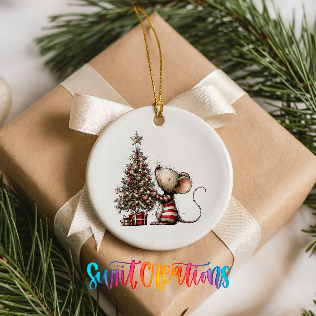 woodland mouse beside a decorated Christmas tree ceramic Christmas ornament displayed on a wrapped Christmas gift