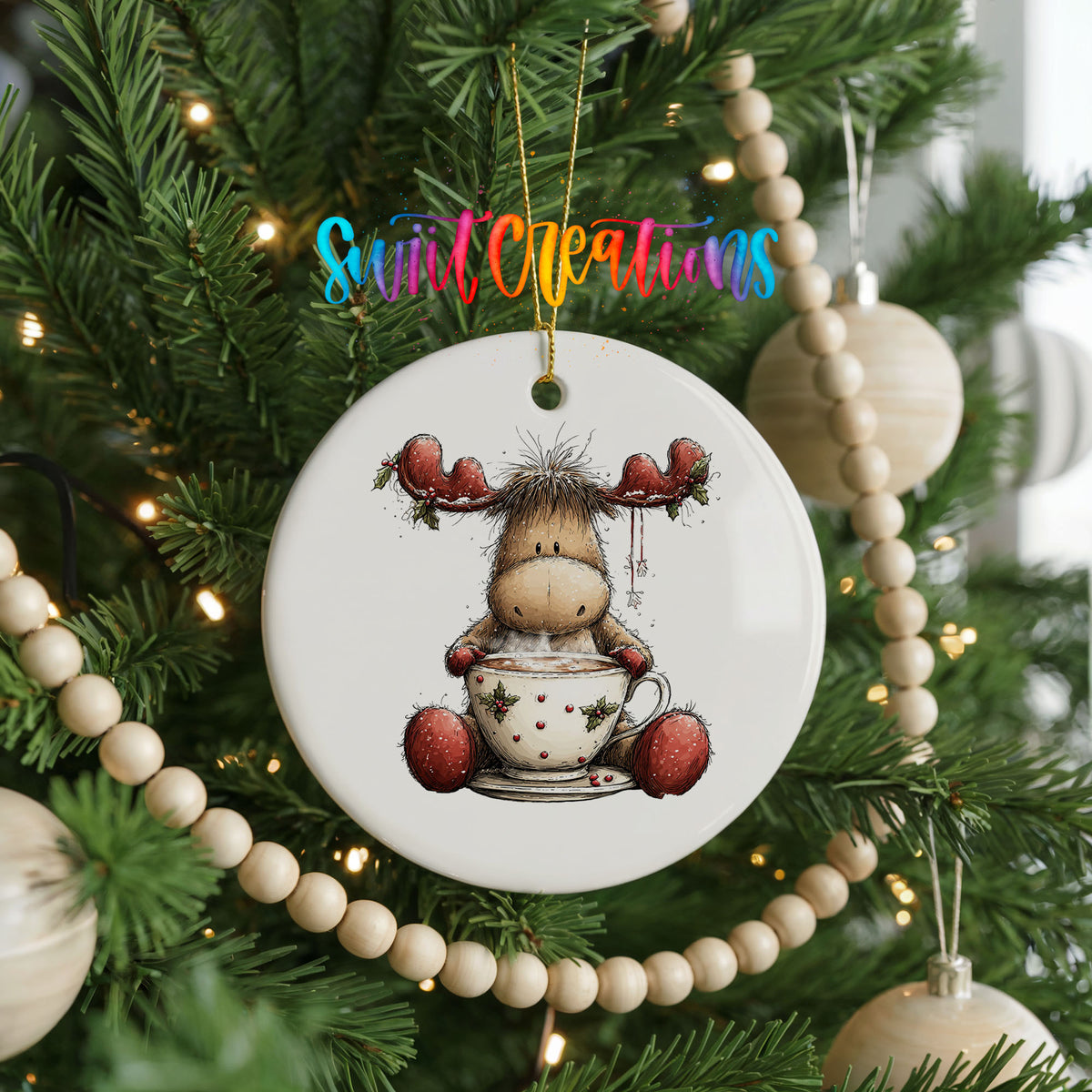 woodland moose in a snowman sweater ceramic Christmas ornament hanging on a green Christmas tree