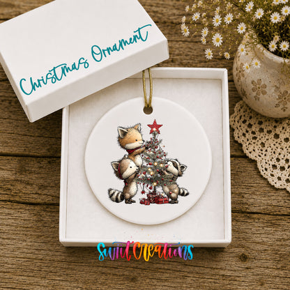 woodland fox beside a decorated Christmas tree ceramic Christmas ornament presented in a gift box