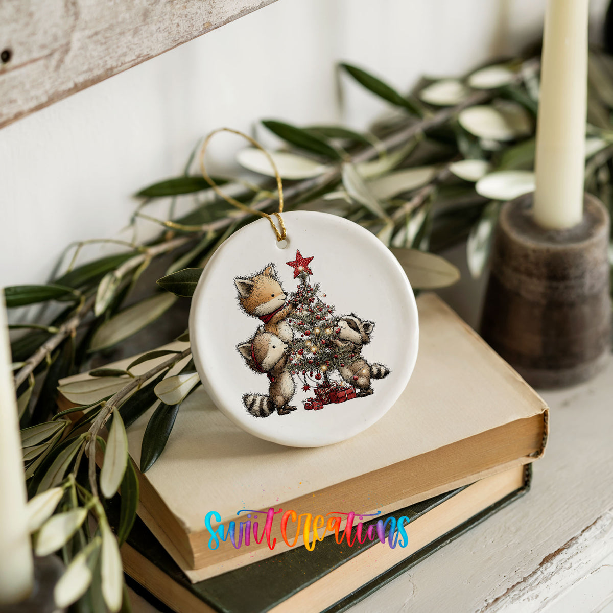 woodland fox beside a decorated Christmas tree ceramic Christmas ornament styled on stacked books with greenery