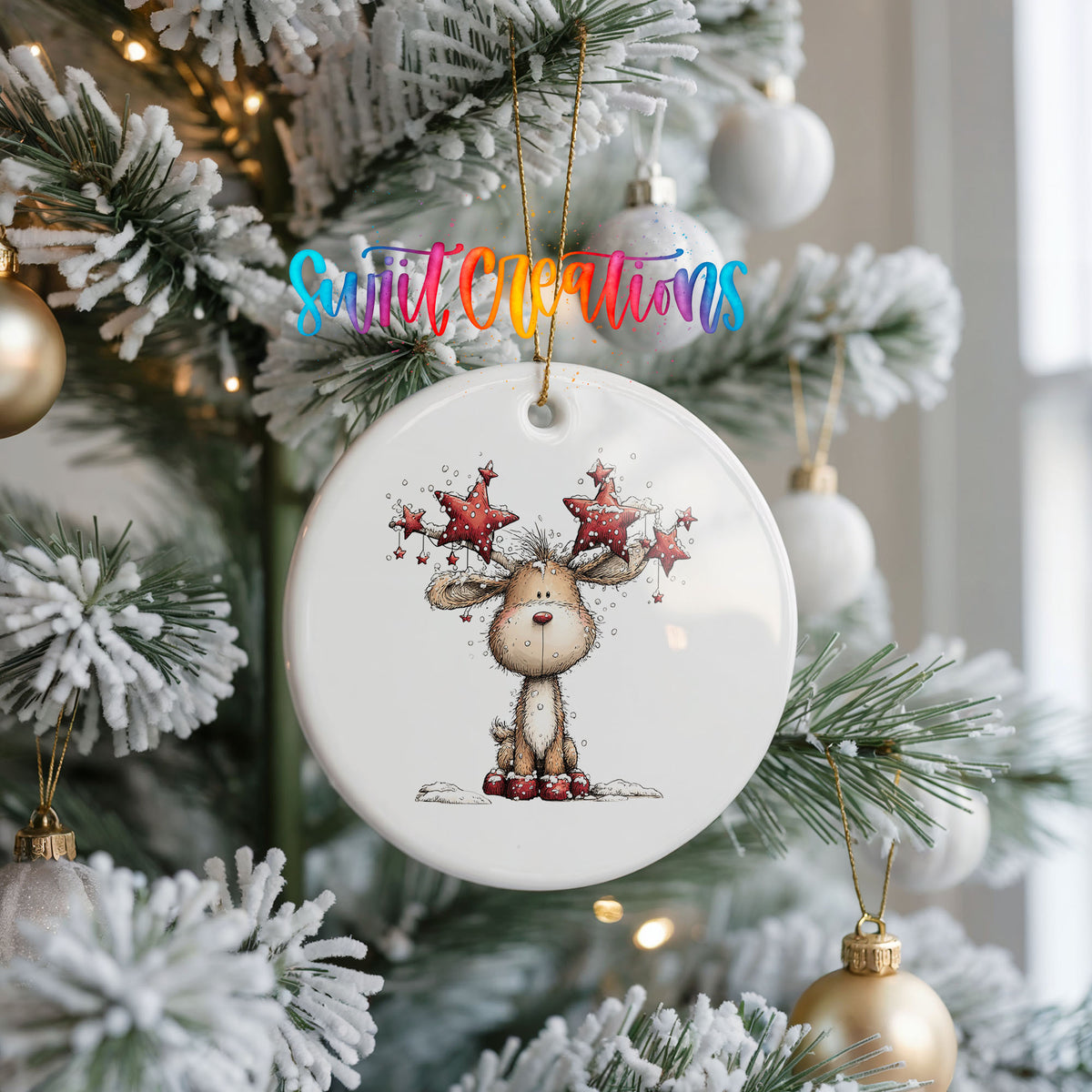 woodland reindeer with red stars on its antlers ceramic Christmas ornament hanging on a frosted Christmas tree