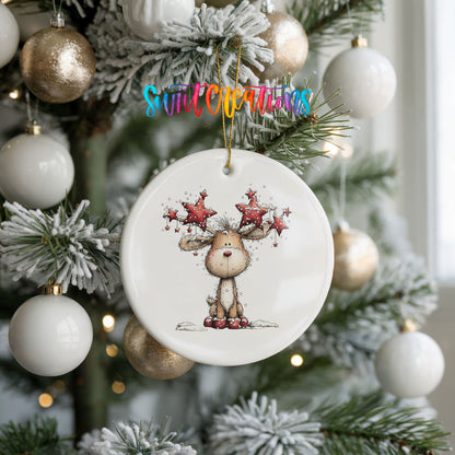 woodland reindeer with red stars on its antlers ceramic Christmas ornament hanging on a frosted tree with ornaments