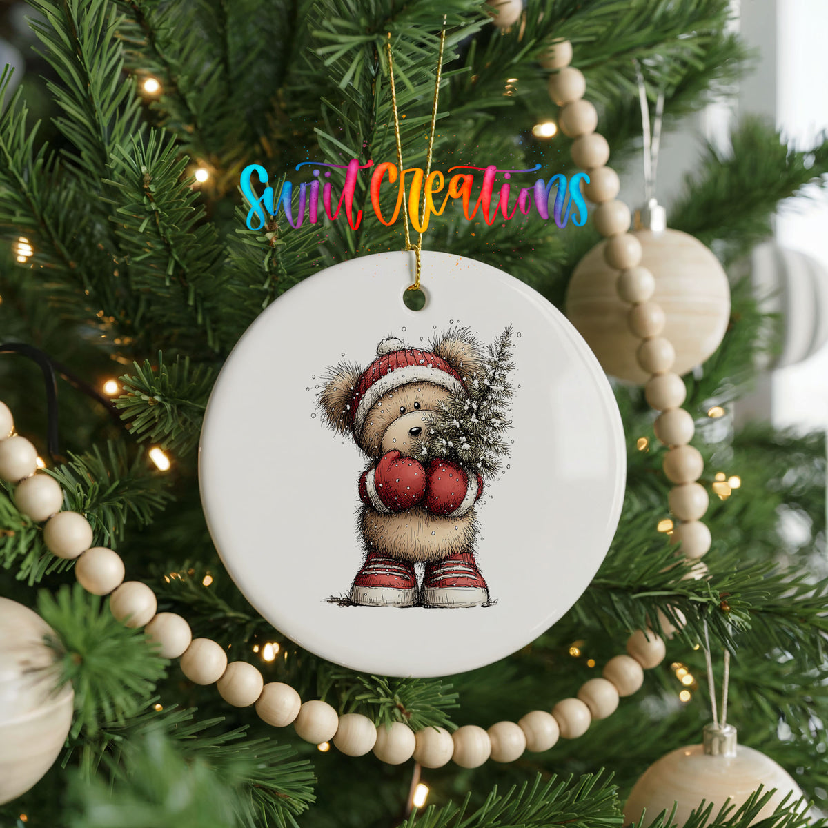 woodland bear in a Santa hat carrying a Christmas tree ceramic Christmas ornament hanging on a green Christmas tree