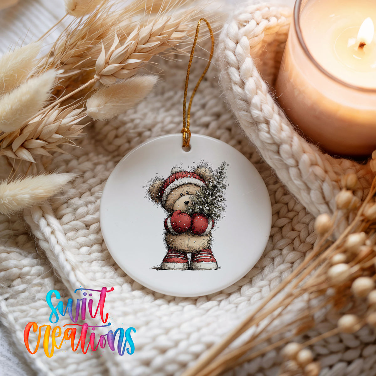 woodland bear in a Santa hat carrying a Christmas tree ceramic Christmas ornament styled on a cozy knit blanket
