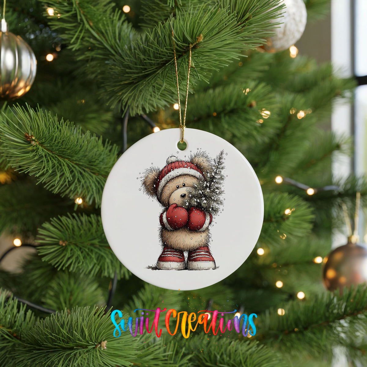 woodland bear in a Santa hat carrying a Christmas tree ceramic Christmas ornament hanging on a lit Christmas tree