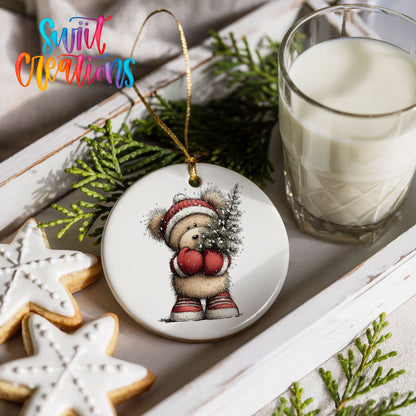 woodland bear in a Santa hat carrying a Christmas tree ceramic Christmas ornament styled with holiday cookies and a candle