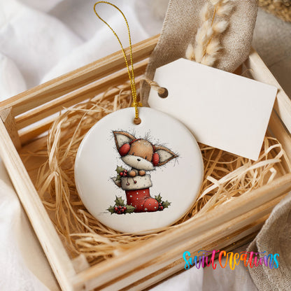 woodland fox sitting in a red Christmas stocking ceramic Christmas ornament displayed in a wooden gift crate
