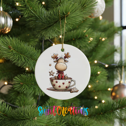 woodland reindeer sitting in a holiday teacup ceramic Christmas ornament hanging on a lit Christmas tree
