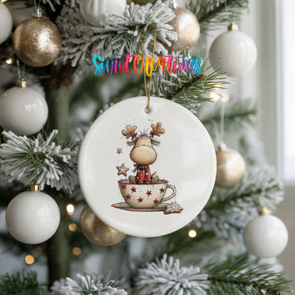 woodland reindeer sitting in a holiday teacup ceramic Christmas ornament hanging on a frosted tree with ornaments
