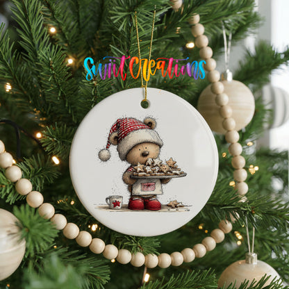 woodland bear in a Santa hat carrying Christmas cookies ceramic Christmas ornament hanging on a green Christmas tree