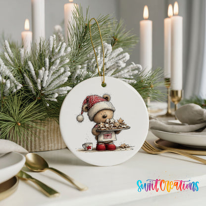 woodland bear in a Santa hat carrying Christmas cookies ceramic Christmas ornament shown in a holiday table setting
