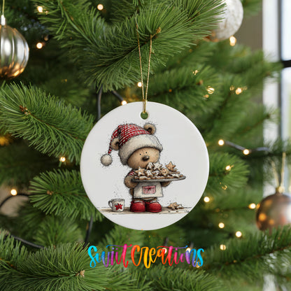 woodland bear in a Santa hat carrying Christmas cookies ceramic Christmas ornament hanging on a lit Christmas tree